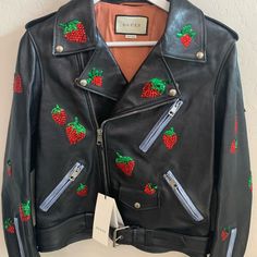 Offers Welcome! This Gorgeous Gucci Biker Leather Grainy Jacket Is Perfect Featuring Exquisite Sequin Embossed Strawberries Throughout, Supple Leather With Contrasting Light Shade Of Blue Boarder Along The Zippers, And Lined In Beautiful Floral Rose Pink Silk. Each Button And Zipper Is Etched With Gucci. Show Off With This Beautiful Leather Motorcycle Jacket From Gucci! This Jacket Is Brand New With Tags And Shows No Wear. Size 42, Fits Like A U.S. 10 Rfid Tag Designer: Gucci Material: Black Lea Gucci Black Spring Outerwear, Gucci Fitted Leather Jacket For Fall, Casual Fitted Gucci Outerwear, Gucci Red Winter Outerwear, Red Gucci Winter Outerwear, Red Gucci Outerwear For Fall, Designer Gucci Leather Jacket With Long Sleeves, Designer Gucci Long Sleeve Leather Jacket, Designer Long Sleeve Gucci Leather Jacket