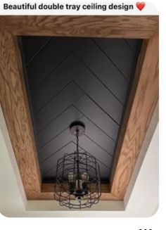 a chandelier hanging from the ceiling in a room with wood paneling and white walls