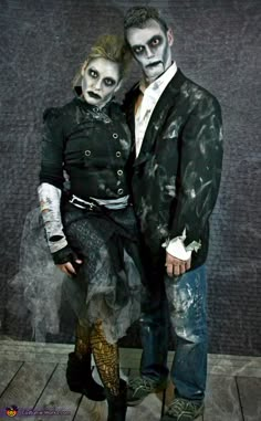 two people dressed up in costumes standing next to each other with makeup on their faces