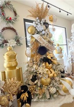 a christmas tree decorated with gold and white ornaments