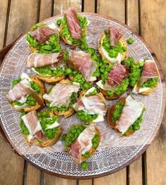 a platter filled with pea and prosciutto crostini on toasted bread