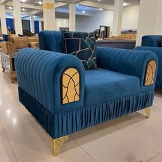 a blue couch sitting on top of a white tiled floor