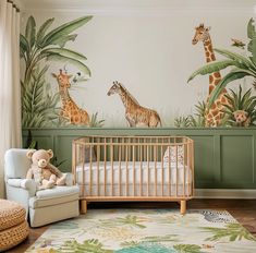 a baby's room with giraffes and palm trees on the wall