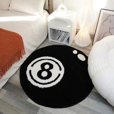 a black and white area rug with an eight - ball design on the floor next to a bed