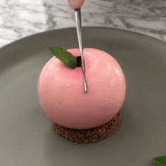 a pink cupcake with a toothpick sticking out of it's center