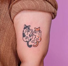 a woman with a cat and dog tattoo on her arm