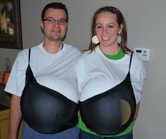 a man and woman dressed up in black and white outfits, standing next to each other