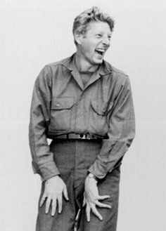 an old black and white photo of a man laughing