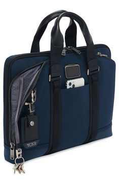 Slim and well-organized, this briefcase delivers all the classic features your day demands but in a sleek profile. Top zip closure Top carry handle; removable, adjustable shoulder strap Exterior zip and magnetic-flap pockets Interior zip, wall and smartphone pockets Padded compartment fits most laptops Nylon Imported Tumi Luggage, Daisy Chains, Sac Lunch, Leather Luggage, Daisy Chain, Monogrammed Items, Mini Wallet, Laptop Pocket, Tablet Laptop