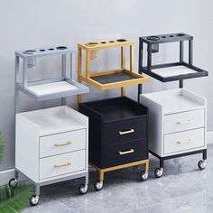 four different types of drawers on wheels in a room with white walls and grey flooring