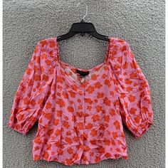 Sanctuary Floral Print Peasant Top Women'S S Pink/Orange Square Neck Button Up Sanctuary Floral Print Peasant Top Women's S Pink/Orange Square Neck Button Up Retail $89.00 Elevate Your Casual Look With This Beautiful Sanctuary Floral Print Peasant Top In Size S. The Blouse Features A Stylish Square Neckline And Elegant 3/4 Puff Sleeves, Perfect For Any Occasion. The Pink And Orange Floral Pattern Is Eye-Catching And Unique, Adding A Touch Of Charm To Your Wardrobe. Made Of 100% Rayon, This Orange Buttoned Top For Vacation, Pink Buttoned Beach Blouse, Orange Buttoned Blouse For Spring, Orange Button Blouse For Spring, Pink Blouse With Buttons For The Beach, Spring Pink Tops With Button Closure, Pink Buttoned Tops For Spring, Pink Buttoned Blouse For Summer, Orange Top With Button Closure For Spring