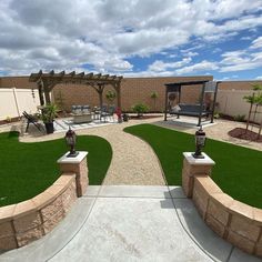 an outdoor area with grass and stone walls