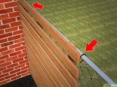 a wooden bench sitting in front of a brick wall with arrows pointing to the left