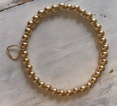 Beautiful 14kt gold filled ball bracelet with a gold open heart charm dangle. Simple and sweet Sizes small 6.5 Medium 7 Large 7.5 Letter Bead Bracelets, Gold Stretch Bracelet, Beaded Ball, Stackable Jewelry, Word Bracelet, Bracelets Gold, Ball Bracelet, Gold Bracelet For Women, Initial Bracelet