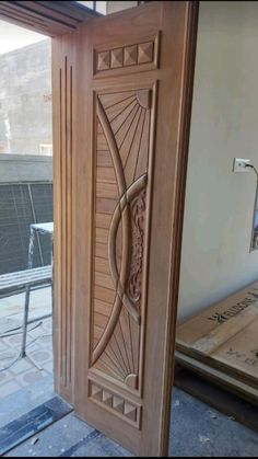 an open wooden door with decorative carvings on it