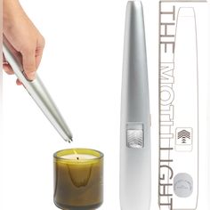 a person is holding a pen over a candle with a lighter in front of it