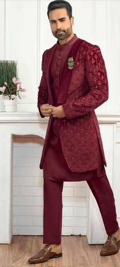 a man in a maroon suit and brown shoes