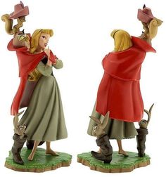 two figurines, one wearing a red coat and the other carrying a dog