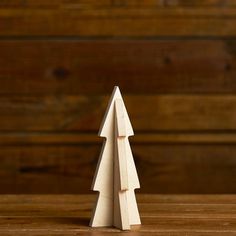 a wooden christmas tree sitting on top of a table