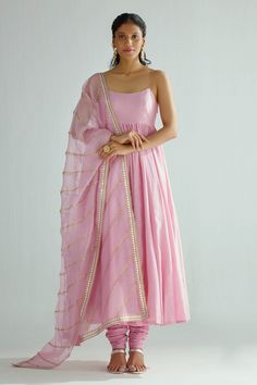 Pink chanderi anarkali with pleated flare and leaf neck. Paired with cotton gathered churidar, organza dupatta with all over stripe pattern zari and sequin embroidery.
Components: 3
Pattern: Embroidered
Type Of Work: Zari and Sequin Work
Neckline: Round Neck
Sleeve Type: Sleeveless
Fabric: Anarkali: Chanderi, Lining: Mulmul, Churidar: Cotton, Dupatta: Organza
Color: Pink
Other Details: 
Round back
Noodle straps
Attached lining
Occasion: Mehendi and Haldi,Puja - Aza Fashions Satin Anarkali, Sleeveless Anarkali, Pink Kurti, Pink Anarkali, Anarkali Lehenga, Anarkali Dress Pattern, Lehenga Online, Traditional Indian Outfits, Fancy Dress Design