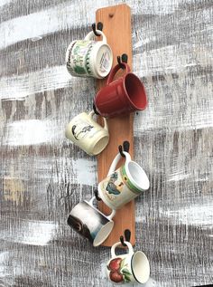 coffee cups are lined up on a wooden board