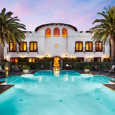 an outdoor swimming pool with palm trees surrounding it and the words bacca resort and spa, california