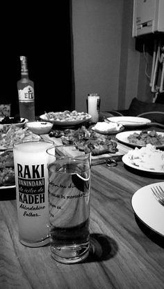 a table full of food and drinks with plates on the table in front of it