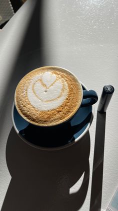 a cappuccino sitting on top of a blue saucer