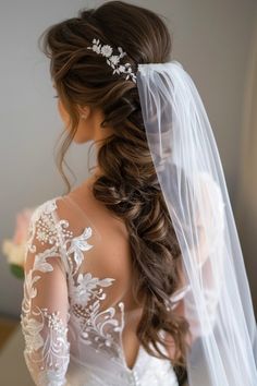 a woman in a wedding dress with a veil on her head