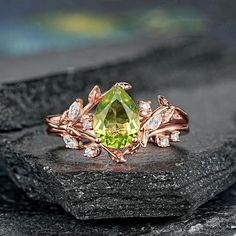 a yellow diamond ring sitting on top of a rock