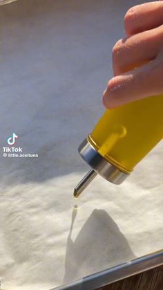 someone is pouring yellow liquid into a container