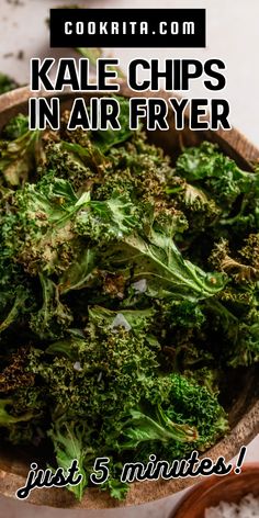 a wooden bowl filled with broccoli on top of a table