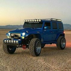 a blue jeep is parked in the desert