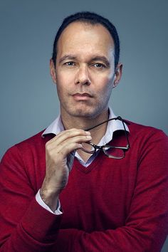 a man in a red sweater and glasses