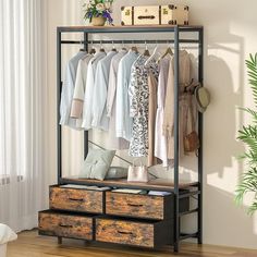 an iron and wood clothing rack with drawers