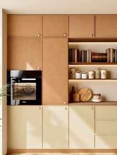 a microwave oven sitting on top of a wooden cabinet next to a shelf filled with books