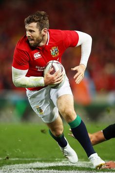 a rugby player is running with the ball