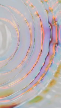 an abstract image of water ripples and circles in blue, pink, yellow and green