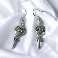 Be The Pop Of The Party With These Fun And Quirky Silver-Plated Pop Lollipop Novelty Earrings. With Traditional Earring Hooks, You Won't Miss A Lick Of The Attention You'll Get When You Rock These Earrings! (Pun Definitely Intended!) Handcrafted By Slow + Sage, The Earrings Measure Approximately 0.75" Wide And 2" Long Including The Ear Hook Novelty Earrings, Candy Jewelry, Traditional Earrings, Earring Hooks, You Rock, Ear Hook, Miss A, Lollipop, Handcrafted Jewelry