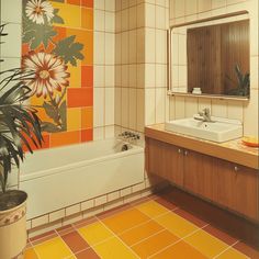 a bathroom with orange and yellow tiles on the wall, sink, mirror and bathtub