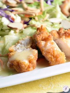 a white plate topped with chicken and salad