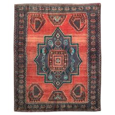 an orange and blue rug with many different designs on it's sides, including the center