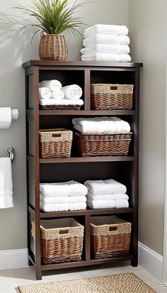 a shelf filled with lots of white towels and wicker baskets on top of it