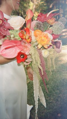 a woman holding a bouquet of flowers in her hands