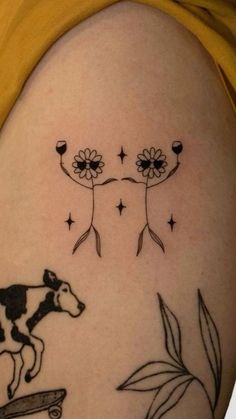 a woman with a tattoo on her arm has a cow riding a skateboard and flowers