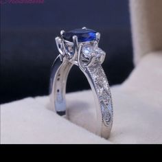 an engagement ring with a blue stone in the center