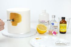 someone is painting the inside of a cake with orange and yellow paint on it, along with other ingredients