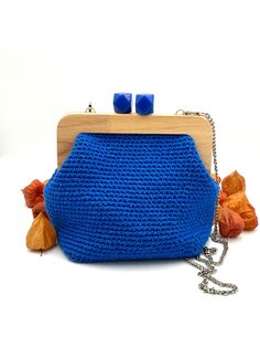 Handmade crochet bag, blue in color and with an elegant design. Made with high quality Adriafil cotton yarn and with shiny inserts that make it elegant but at the same time sporty. The wooden click clack closure makes it the perfect accessory for any occasion. Its compact but roomy size allows you to carry everything you need, such as a cell phone, wallet and keys. An ideal gift for those who appreciate timeless elegance and attention to detail, perfect for surprising a girlfriend, a friend, a m Elegant Blue Crochet Bag For Everyday Use, Elegant Blue Crochet Bag, Elegant Blue Rectangular Crochet Bag, Blue Crochet Bag For Gift, Elegant Handmade Blue Crochet Bag, Elegant Blue Handmade Crochet Bag, Handmade Blue Crochet Bag As A Gift, Handmade Blue Crochet Bag As Gift, Handmade Blue Crochet Bag For Gift