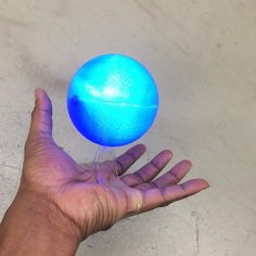 a person holding a blue ball in their hand