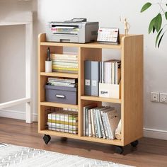 a book shelf with many books on it and a printer sitting on top of it